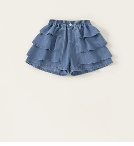 Detail view of girls blue denim shorts featuring tiered ruffles and elastic waist