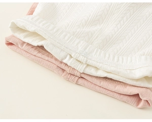 Detailed macro view of pink and white knit toddler leggings with herringbone pattern