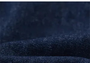 Close-up of deep blue denim fabric texture and twill weave pattern for kids shorts