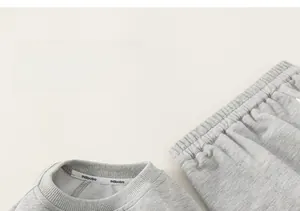 Close-up of soft grey cotton fabric texture and neckline detail of children leisure set
