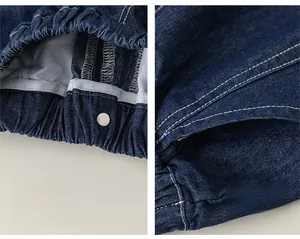 Detailed shot of dark blue denim shorts with elastic waistband and white stitching