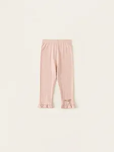 Pink knit toddler leggings with ruffled cuffs, bow and pearl detail, spring outfit style