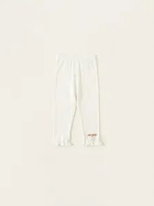 Toddler girl cream knit leggings with ruffled hems and delicate bow charms detail