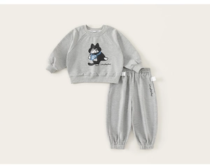 Detail of grey cotton kids tracksuit featuring cartoon cat print and ribbed cuffs