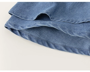 Close-up of blue denim skirt-pants showing smooth stitching and twill fabric texture