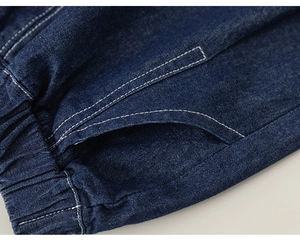 Close-up of kids denim shorts showing elastic waistband and white contrast stitching