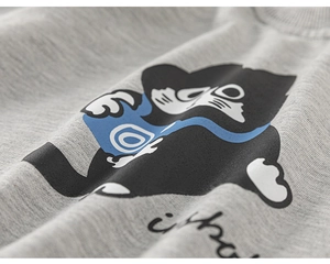 Detail shot of a grey cotton sweatshirt featuring a cute cartoon cat and soft knit fabric