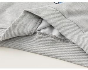 Close-up detail of grey kids' sweatshirt rib-knit hem and soft French Terry fabric texture