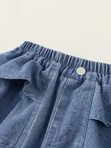 Girls dark blue denim shorts with elastic ruffle waist and silver button detail