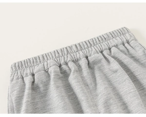 Detail of grey marl heather knit pants showing elastic waistband and stitching