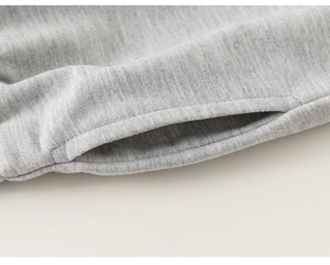 Detailed close-up of pocket opening and heather gray knit texture on boys' casual pants