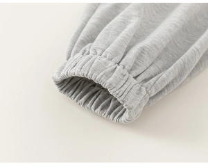 Detailed macro view of the grey ribbed cuffs and stitching on cotton blend kids' joggers