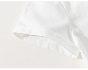 Detailed close-up of white cotton short sleeve cuff showing double-needle stitching quality