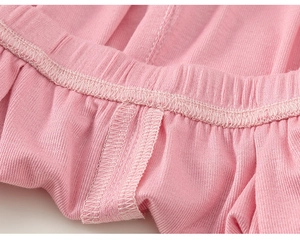 Detail of pink ribbed knit fabric showing elastic waistband and neat stitching quality