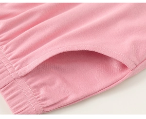 Detail of pink cotton knit shorts showing high-quality side pocket stitching and soft fabric