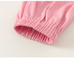 Close-up of pink cotton knit fabric with elastic smocked cuffs on children's clothing