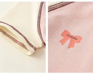 Detail of pink ribbed fabric with bow print and red contrast stitching on short sleeves