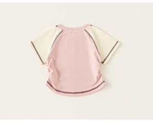 Detail of baby raglan T-shirt with contrast stitching and soft cotton fabric texture