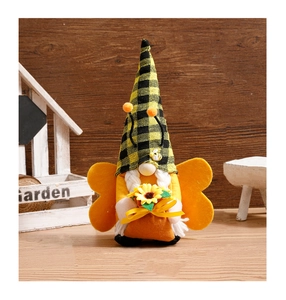 Close-up of a bee gnome doll with sunflower detail on a rustic wooden background