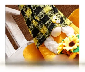 Macro shot of bee-themed gnome face with knit hat, wooden nose and sunflower detail