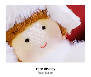 Close-up of the cute plush angel doll face with white fur hood and embroidered features