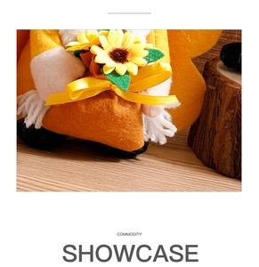 Detailed close-up of a sunflower gnome doll featuring orange felt and white tassel beard