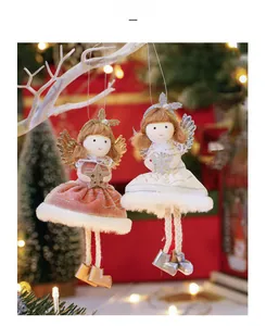 Close-up of plush angel girl dolls in pink and white dresses with sparkling wings decoration