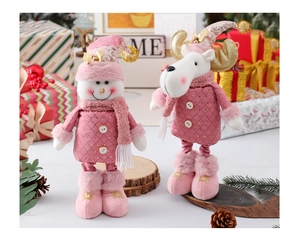Detailed plush Christmas figurines of reindeer and snowman with pink plaid and gold accents