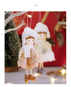 Close-up of plush Christmas angel dolls with fluffy scarves and ear muffs on tree