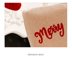 Close-up of linen fabric texture with red Merry typography and festive Christmas details
