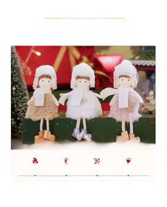 Close-up of plush angel doll ornaments with cozy scarves and star accents for Christmas