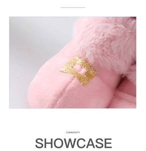 Detailed macro view of pink plush slippers with sparkling golden glitter buckle detail