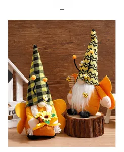 Detailed view of bee-themed gnome plush toys with sunflower and honey pot on wood