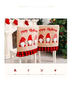 Detail of Christmas chair covers with gnomes, red and black plaid ruffles on white chair