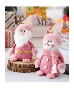 Dettaglio delle bambole di Natale in peluche rosa e oro rosa con paillettes