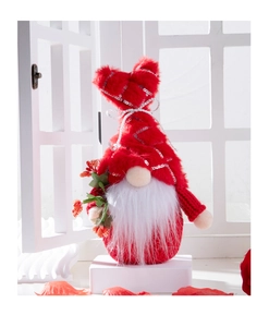 Detail of red plush gnome with silver sequins holding festive berries for home decor