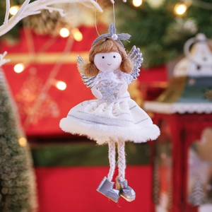 Christmas angel doll ornament with white mesh dress and silver wings hanging on a tree