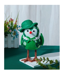 Close-up of green plush bird decoration with clover patterns and a tiny top hat