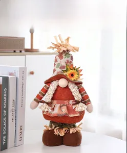 Detail of harvest gnome figurine with maple leaf hat and sunflower on rustic background