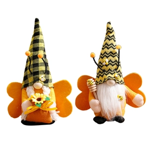 Pair of bumblebee gnome dolls with sunflower and honey stirrer on a clean white background