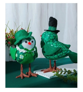 Detail of St. Patrick's Day glowing green bird plush with clover patterns and lace