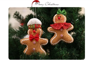 Macro detail of gingerbread man plush ornaments with festive hats on a Christmas tree