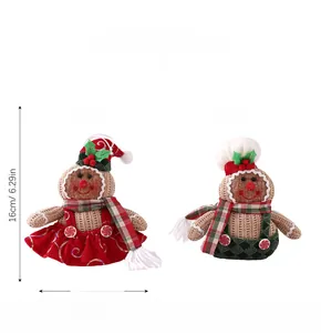 Detailed view of gingerbread plush dolls with Christmas hats and scarves, size and weight info