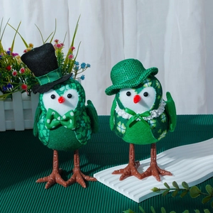 A pair of St. Patrick's Day glowing green plush birds with clovers and festive hats