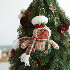 Macro shot of a knitted gingerbread man Christmas ornament with green plaid overalls