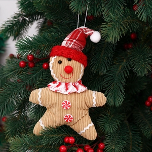 Gingerbread man Christmas tree ornament made of plush corduroy with a festive red hat