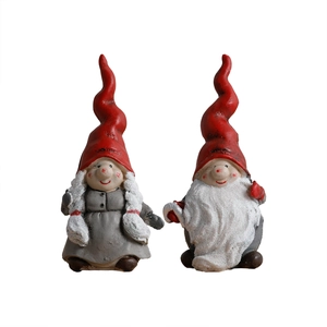 Pair of festive resin Christmas gnomes with red pointed hats for holiday decor