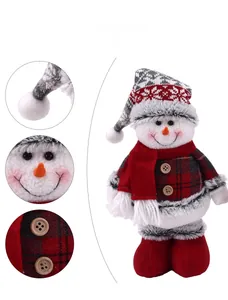 Detail view of a Christmas snowman plush with snowflake hat and red checkered body fabric