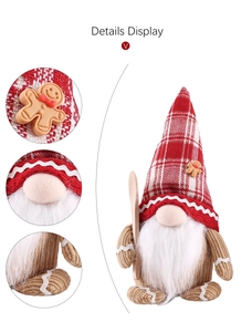 Detail view of gnome plush featuring red plaid hat and gingerbread man decorative charm