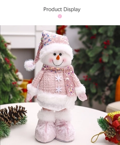 Close-up of pink sequined snowman doll with tweed jacket and snowflake decor